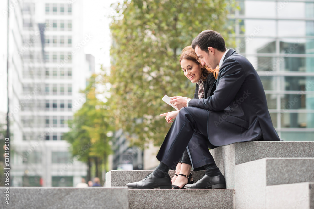 Businesspeople in city using digital tablet Businesspeople in city using digital tablet