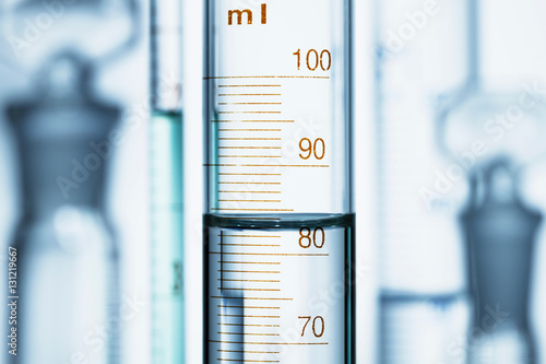 Meniscus. Curved surface (meniscus) of water in graduated cylinder. Liquid volume measured by reading the scale at the bottom of the meniscus. The reading is 82.6 mL photo