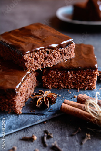 Delicious cocoa gingerbread cake with marmalade and chocolate topping