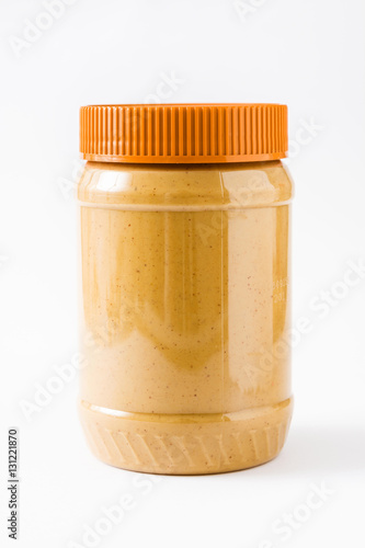 Creamy peanut butter jar isolated on white background
