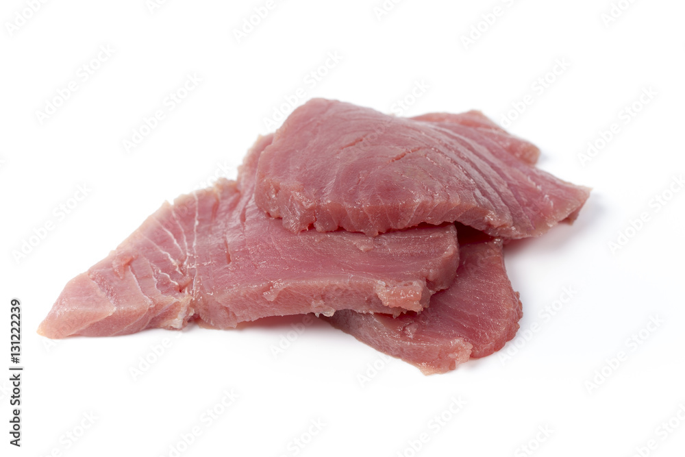 Fresh big raw fillet steak of Tuna with blue dumbbells and green apple on white background for gourmet or vegetarian. Healthy low fat full of omega 3 acid dinner for people on diet after workout.