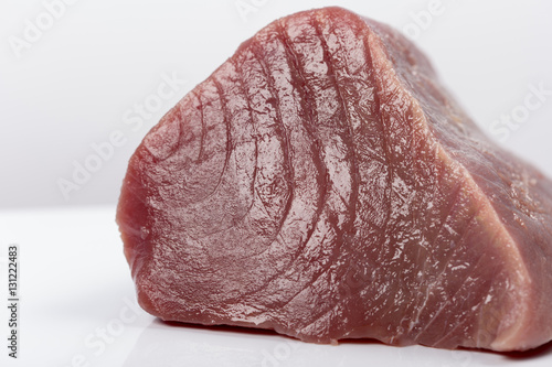 Fresh big raw fillet steak slices of Tuna for BBQ barbecue on white background for gourmet or vegetarian Healthy low fat full of omega 3 acid dinner for people on diet after workout