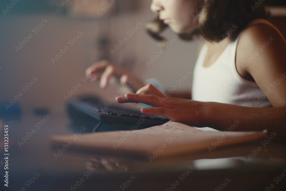 Girl using computer in dimly-lit room Girl using computer in dimly-lit room