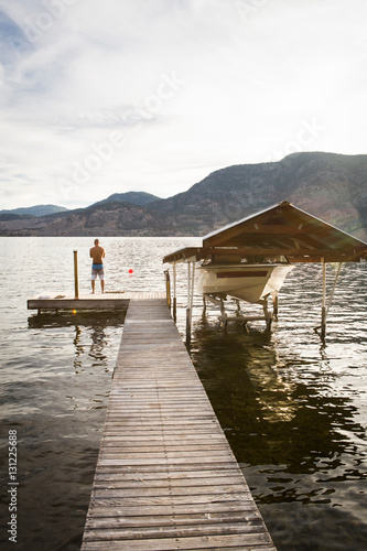 Man with boat moored on pier, Penticton, Canada