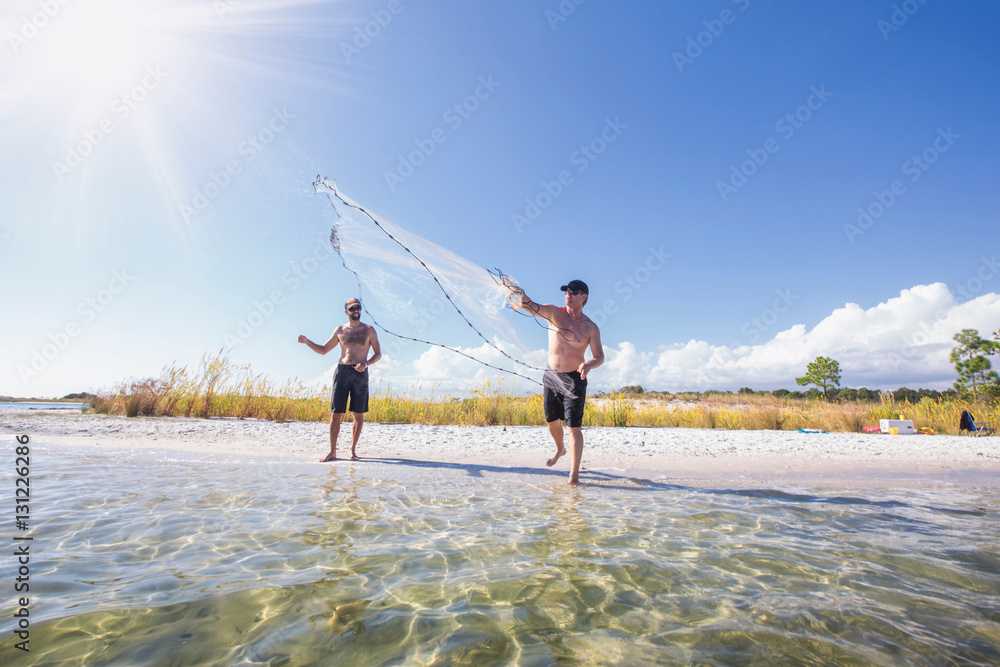 Man demonstrating how to cast net for fish bait , Fort Walton Beach, Florida, USA Stock Photo