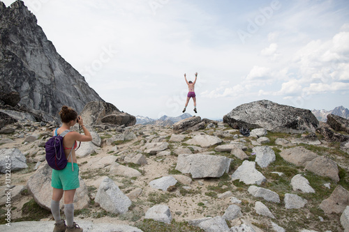 Young woman photographing friend, The Enchantments, Alpine Lakes Wilderness, Washington, USA