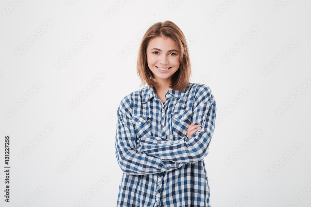 Cheerful smiling woman in plaid shirt standing with arms folded Cheerful smiling woman in plaid shirt standing with arms folded