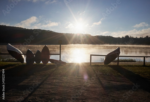 Canoes leaning against railing beside lake, Arrowhead Provincial Park, Ontario, Canada