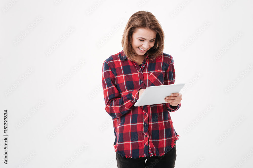 Smiling young woman using tablet computer Smiling young woman using tablet computer