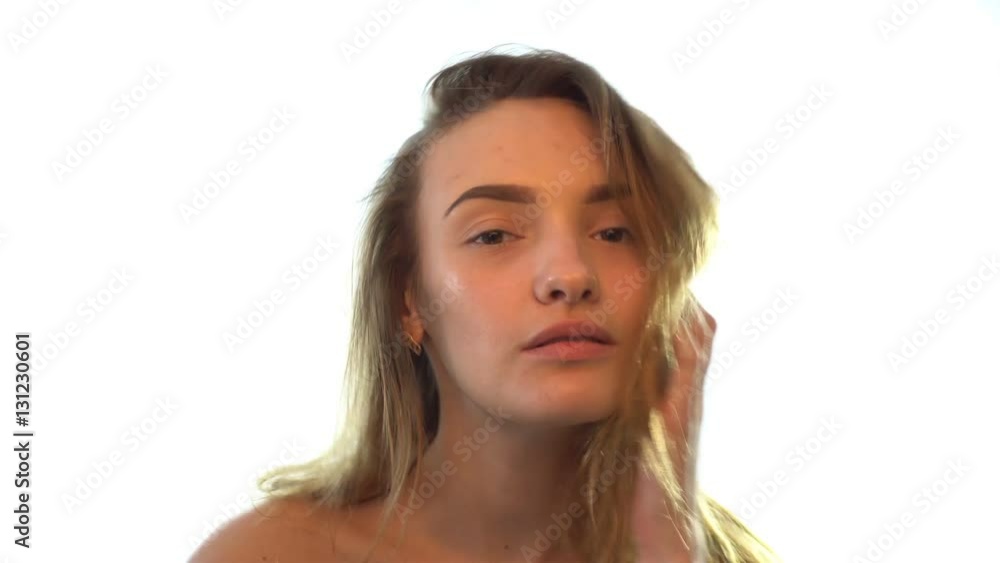beautiful girl without makeup looks straight and straightens the wet hair beautiful girl without makeup looks straight and straightens the wet hair