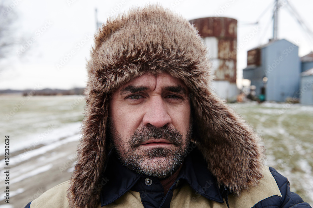 Portrait of mature man wearing trapper hat Portrait of mature man wearing trapper hat