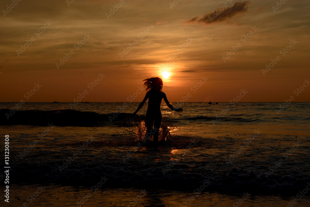 Naklejka premium Girls sadow on the beach