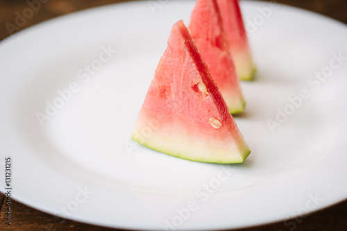 Small pieces of watermelon on white plate.