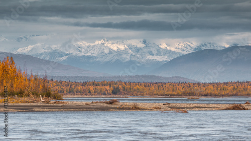 Beautiful colors of fall early morning at Susitna River with the Denali National Park in background. Close to Talkeetna river. Alaska. photo