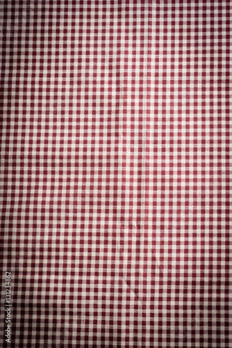 the checkered tablecloth on black stone background. Use for background.