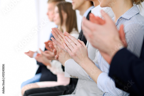 Close up of business people hands clapping at conference