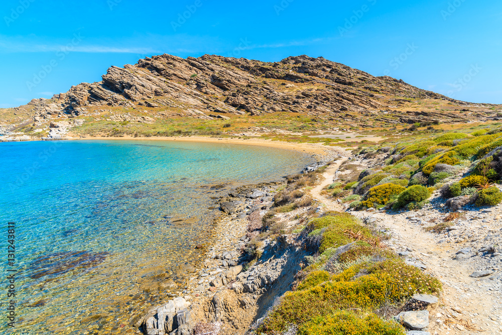 Beautiful coastal path along crystal clear sea water in Monastiri bay on Paros island, Greece