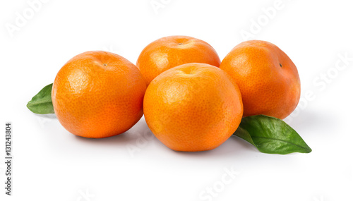 Fotografie Ripe mandarin with leaves close-up on a white background.