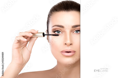Glamorous young woman applying mascara