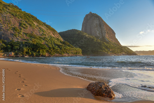 The empty beach Praia Vermelha and Sugarloaf mountain on the background at sunny early morning, Rio de Janeiro, Brazil