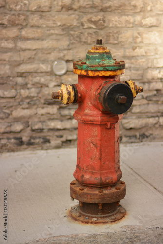 Vvintage red metallic fire hydrant in the ground for fighting urban fires. photo