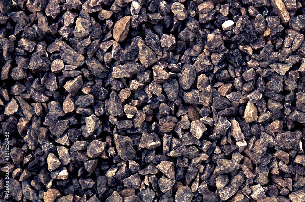 aggregate - a stack of gravel / grit of glauconite sandstone, consisting of gray coarse stones, crushed and broken at a stone pit to similar sizes. Irregular shapes and dark color tone. aggregate - a stack of gravel / grit of glauconite sandstone, consisting of gray coarse stones, crushed and broken at a stone pit to similar sizes. Irregular shapes and dark color tone.