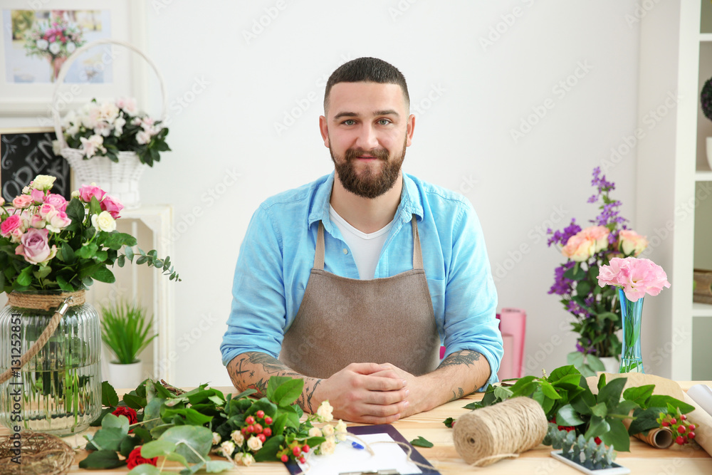 Handsome bearded florist at workplace Handsome bearded florist at workplace