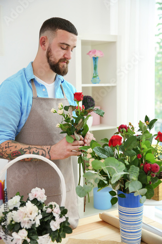 Handsome bearded florist at workplace