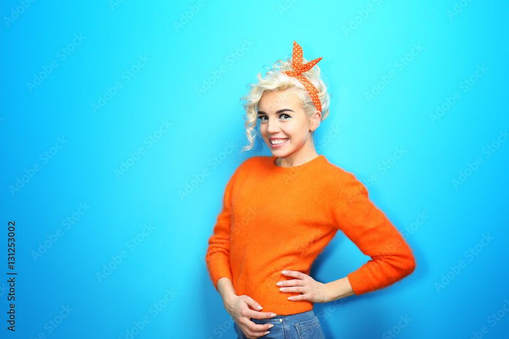 Portrait of funny emotional girl on blue background