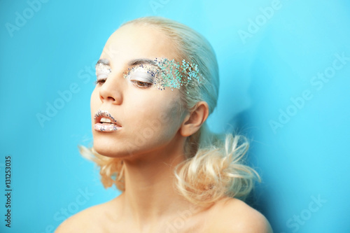 Beautiful woman with fashion make up on blue background