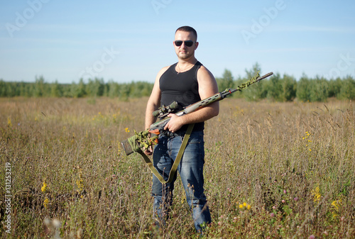 A man with a gun in his hands