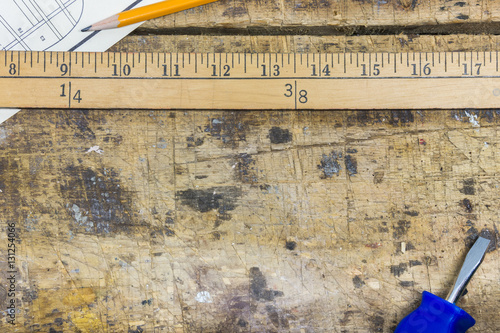 Workshop background with yard meter stick, screwdriver, pencil a