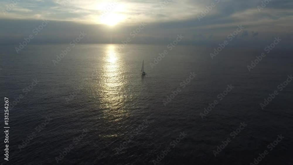 Flying over sailboat in the ocean at sunset. Boat in sunset. Aerial view. Flying over sailboat in the ocean at sunset. Boat in sunset. Aerial view.
