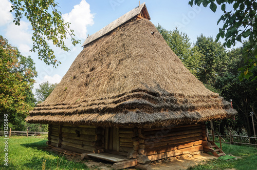 Old wooden house with straw roof