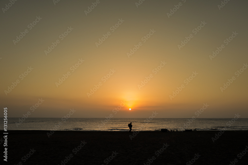 one person silhouette in front of sunrise in jeju island