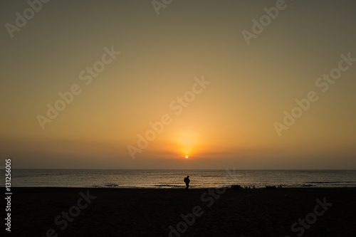 one person silhouette in front of sunrise in jeju island