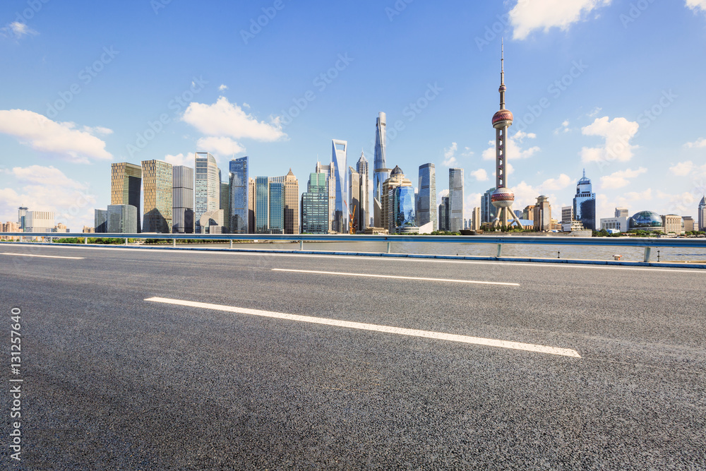 Asphalt road and modern skyline and buildings in Shanghai