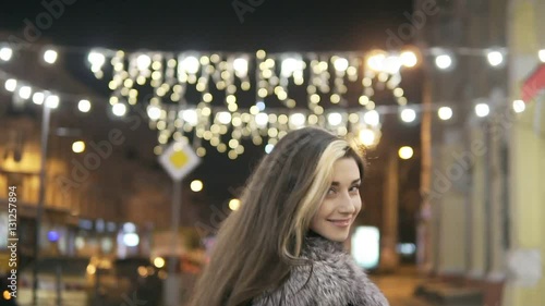 Wallpaper Mural Young beautiful pretty woman walking and smiling at city street in the night against evening lights Torontodigital.ca