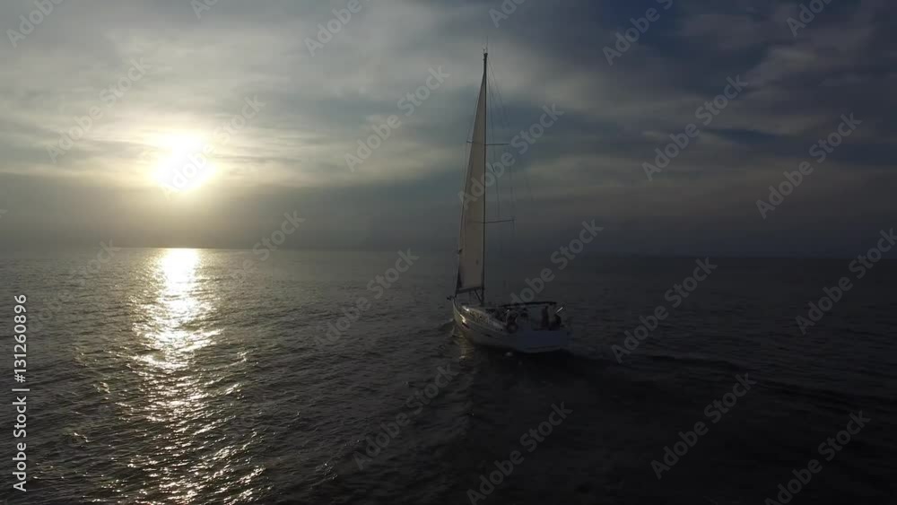 Sailing yacht in the ocean. Sun ahead. Flying near 50 feet sailboat in the ocean. Sailing yacht in the ocean. Sun ahead. Flying near 50 feet sailboat in the ocean.