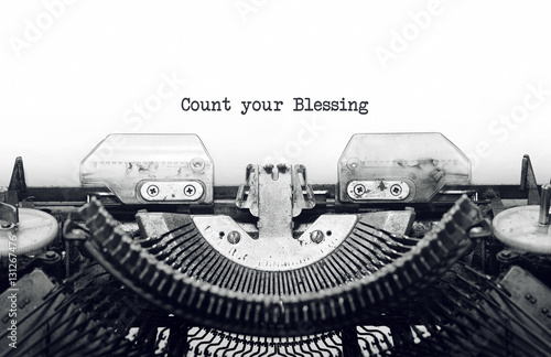 Vintage typewriter on white background with text Count your Blessing