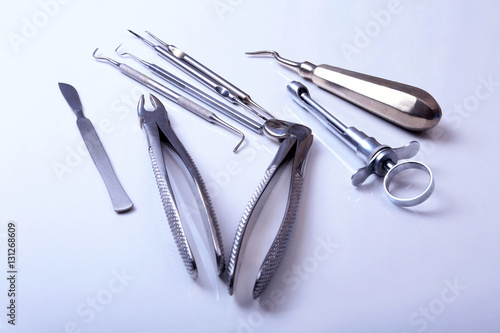 surgical instruments and tools including scalpels, forceps tweezers arranged on a table for surgery