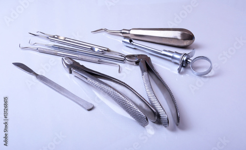 surgical instruments and tools including scalpels  forceps tweezers arranged on a table for surgery