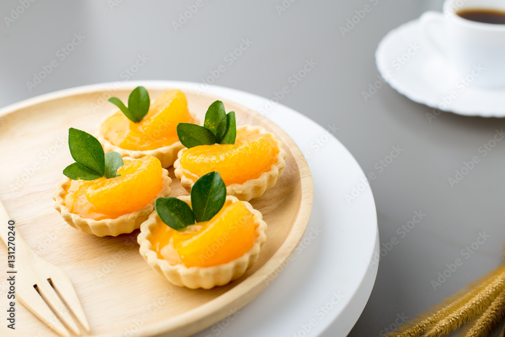 cake basket on a table,orange cake with black coffee. cake basket on a table,orange cake with black coffee.
