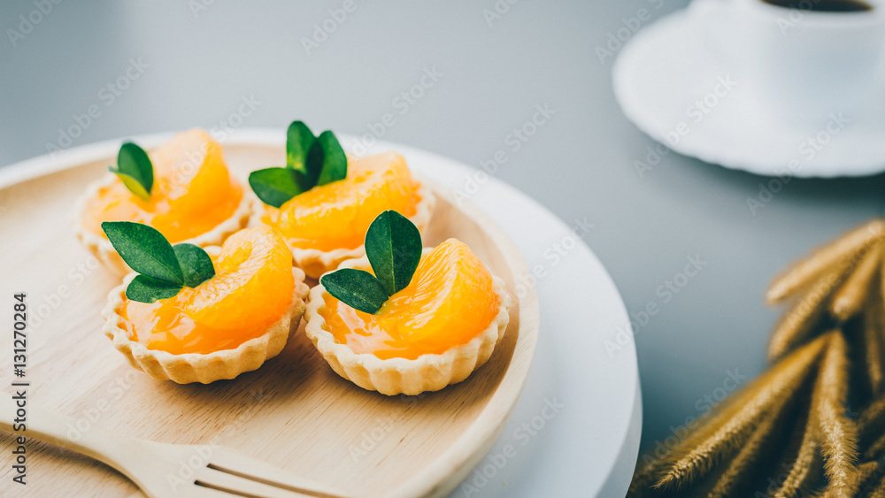 cake basket on a table,orange cake with black coffee. cake basket on a table,orange cake with black coffee.