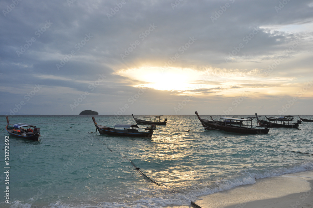Boat in the sea with sunrise background Boat in the sea with sunrise background