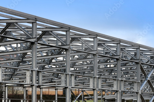 Metal frame of an industrial building, warehouse in the construction process in perspective.