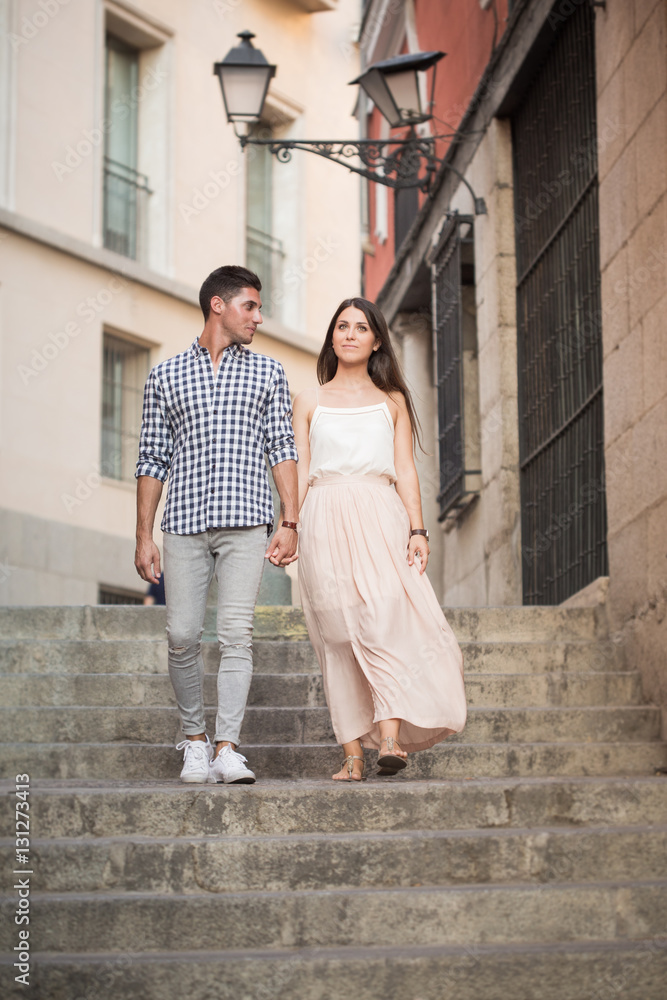 Portrait of smiling young and beautiful couple walking