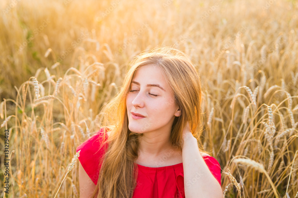 Beautiful Young Woman Outdoors. Enjoy Nature. Girl in the field Beautiful Young Woman Outdoors. Enjoy Nature. Girl in the field