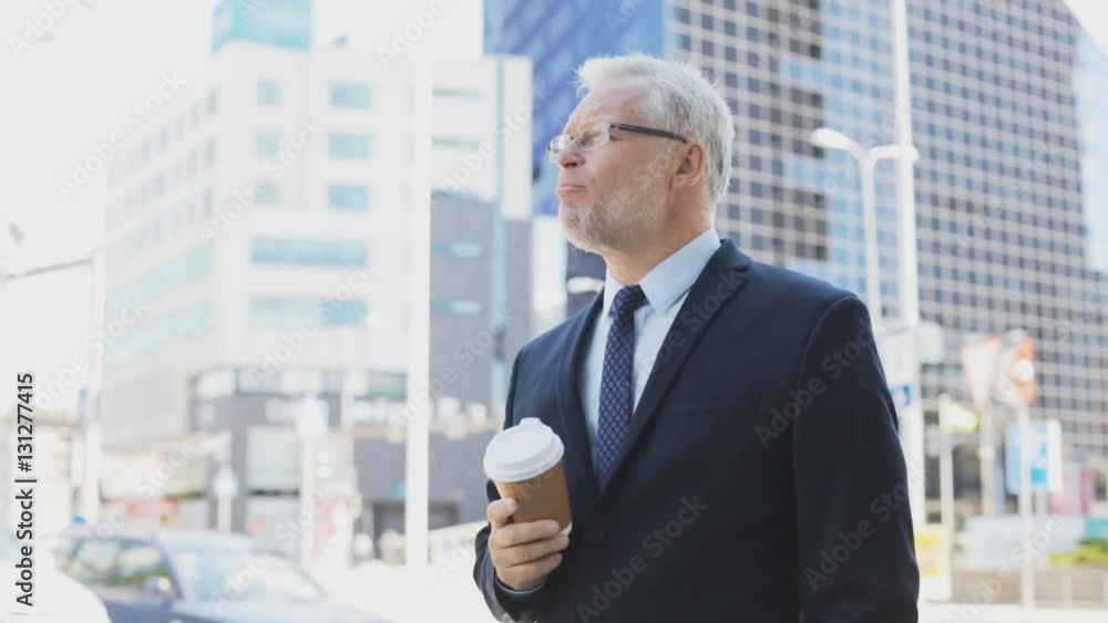 senior businessman drinking coffee on city street senior businessman drinking coffee on city street