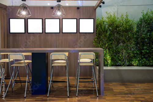 Long table and chairs with empty white isolated frame on the woo